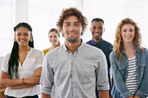 Cropped portrait of a group of young coworkers standing in a brightly lit office